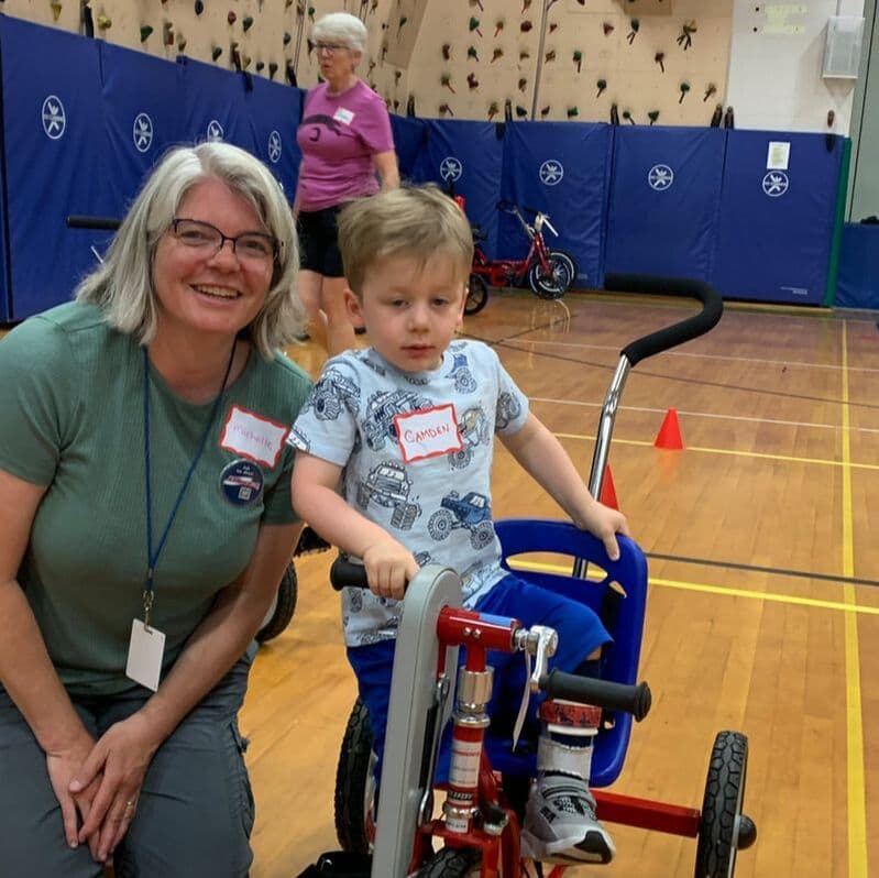 Vermont AMBUCS volunteers helping a rider at a bike fitting event